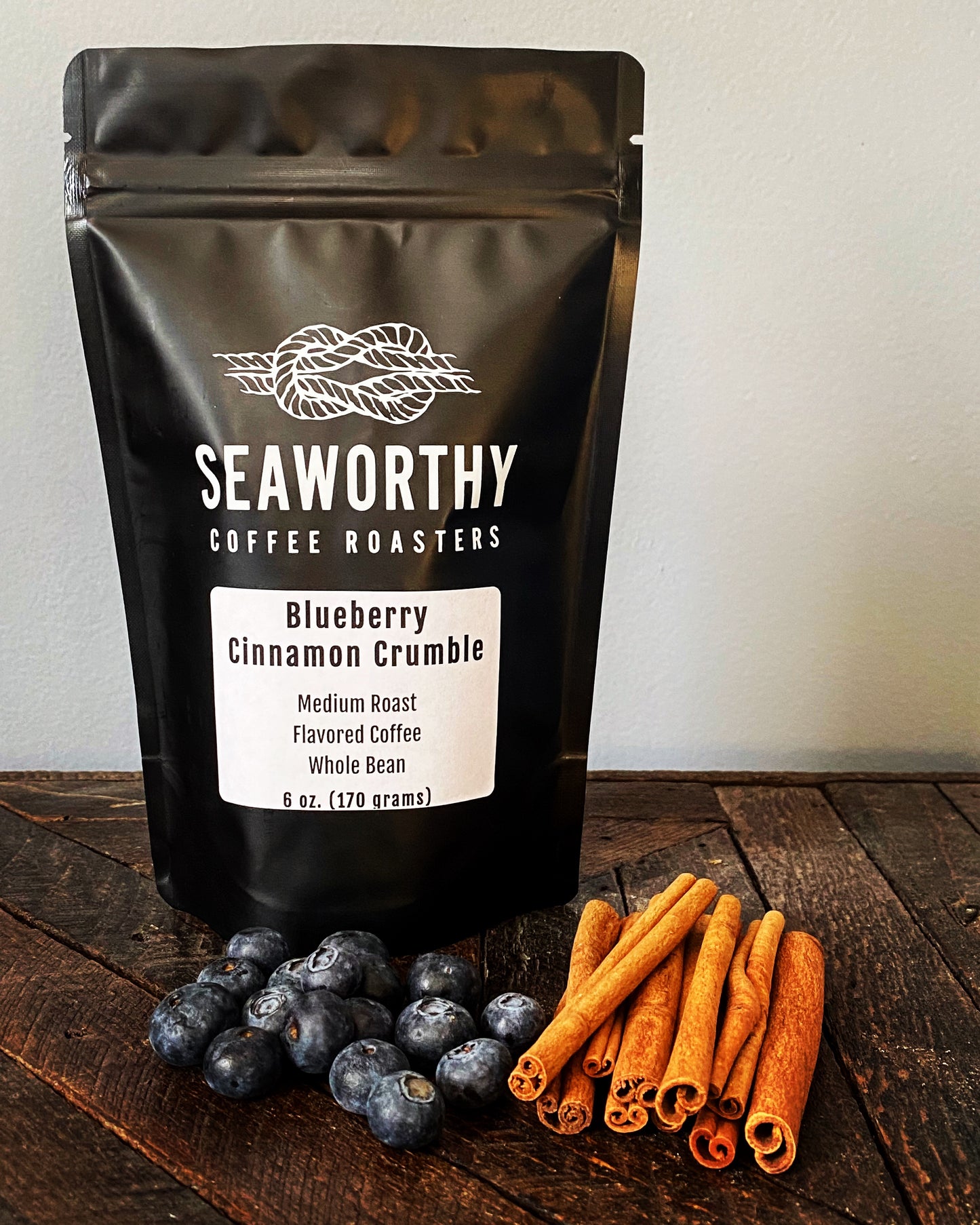 Seaworthy slow roasted, small batch coffee 1 pound bag of Blueberry Cinnamon Crumble flavored coffee. Blueberries, cinnamon sticks, bag of Seaworthy Coffee.