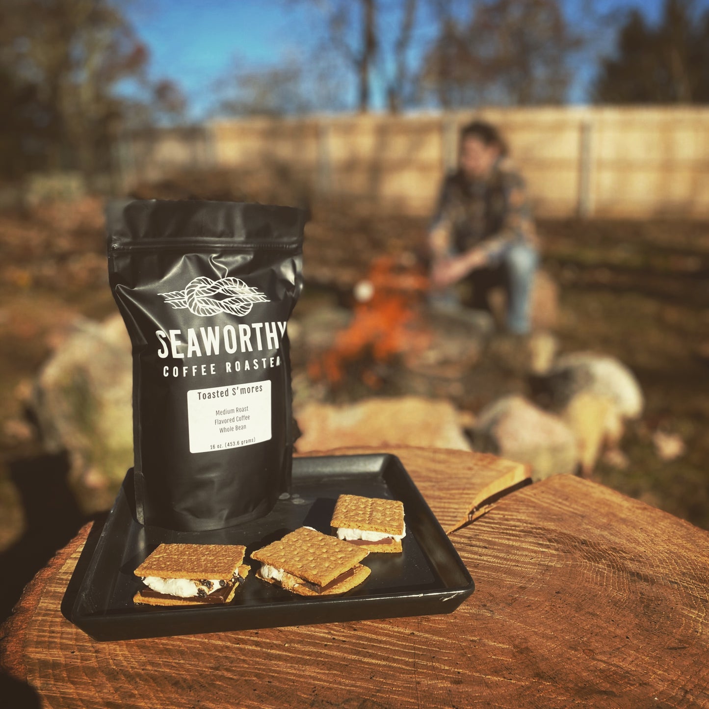 Seaworthy slow roasted, small batch, low acid coffee. 1 pound bag of Toasted Smores flavored coffee. Plate of smores with person toasting marshmallows over a fire.