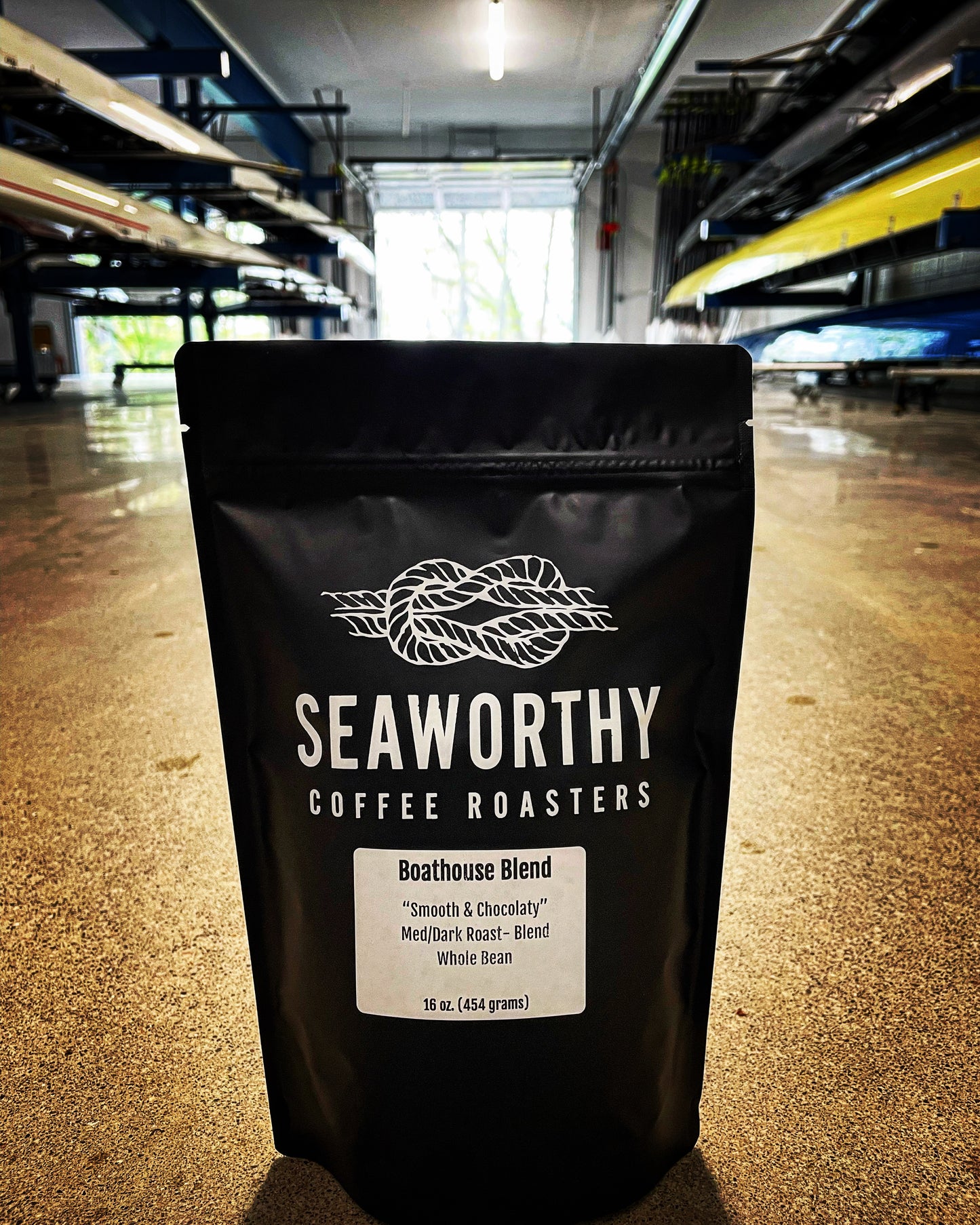16 ounce bag of boathouse blend seaworthy coffee in a rowing boathouse