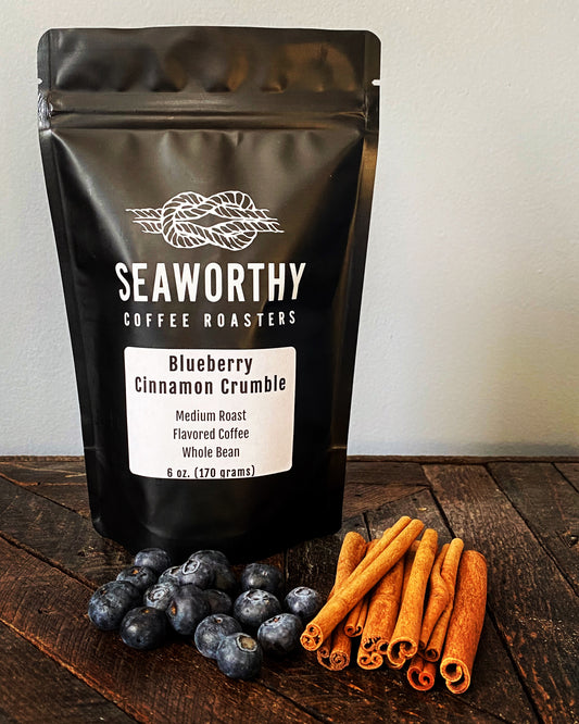 Seaworthy slow roasted, small batch coffee 1 pound bag of Blueberry Cinnamon Crumble flavored coffee.  Blueberries, cinnamon sticks, bag of Seaworthy Coffee.
